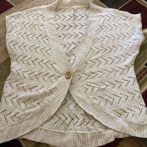 Cream colored short sleeve cardigan.